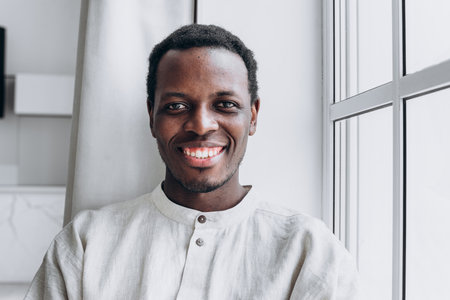 Portrait of handsome African-American man on grey backgroundの写真素材