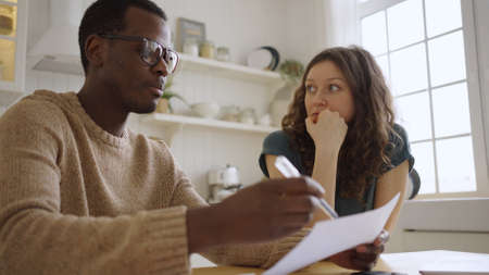 Woman looks at realtor telling details of apartment purchase