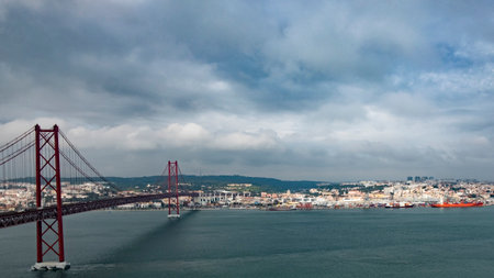 Panoramic View of 25 de Abril Bridge and Lisbon Skyline on a Cloudy Day