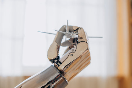 Bionic robot arm holding miniature model of airplane, symbol of travel and adventureの写真素材