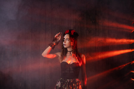 Woman in Dia de los Muertos costume with red lighting and smoke effectの写真素材