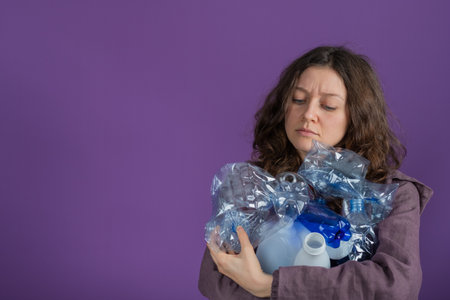Woman poses with a worried expression, clutching a stack of used plastic bottles against a vivid...