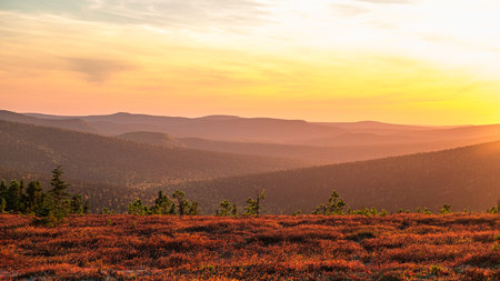 Beautiful autumn landscape with mountains and warm sunset glowの写真素材
