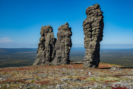 The manpupuner rock formations, also known as the seven strong men, are towering over a mountain plateau in the northern ural mountainsの写真素材