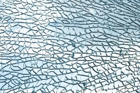 Broken glass, lots of cracks, the texture of shards against the sky