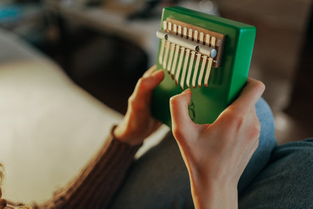 Woman playing kalimba, relaxing music and sound therapyの写真素材