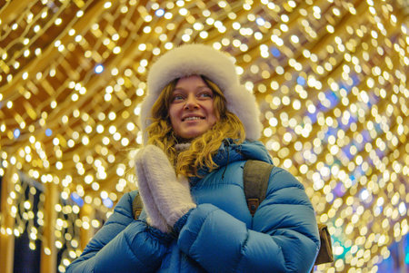 Tourist enjoying christmas market lights wearing winter clothes