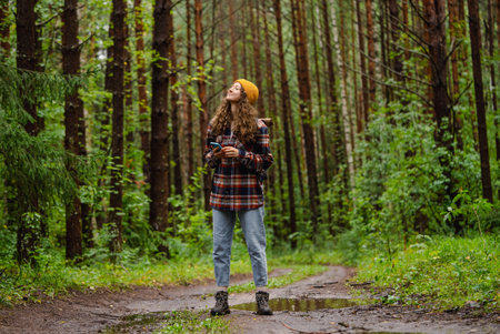 Hiker using smartphone gps app enjoying hiking trail in forestの写真素材