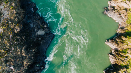Two rivers merging, creating stunning color contrast from aerial viewの写真素材