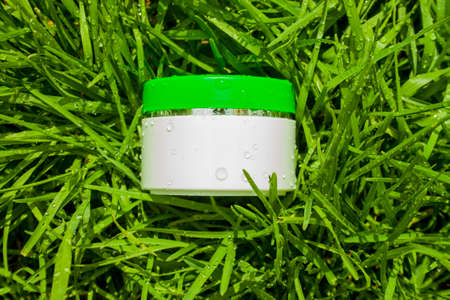 Cosmetic cream on a background of green grass. Natural cosmetic.の写真素材