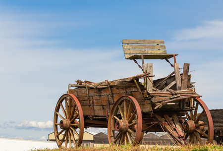 Old wooden brocken cart in the field. Selective focus, close up, street photo, travel photo.