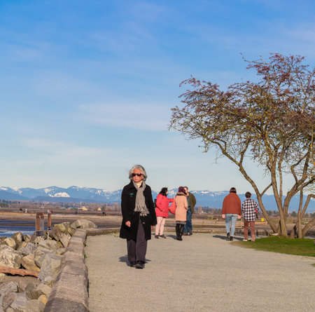 White Rock, BC, Canada-March 8,2021. People at Blackie Spit Park walking by the seashore. Travel photo, street view, selective focusのeditorial素材