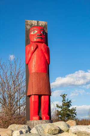 Tsawwassen First Nation Final Agreement Place. Red wood carved totem pole in Tsawwassen Ferry Terminal, British Columbia, Canada-February 26,2020. Travel photo, street view, copy space.のeditorial素材