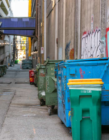 garbage wheelie bins for recycling household waste lined up on the street of Vancouver city BC. Street view, travel photo, selective focus.のeditorial素材
