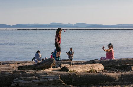 A view of the family with children on the beach of Stevenson Park, BC, Canada-april 18,2021. Street view, travel photo, concept photo family.のeditorial素材