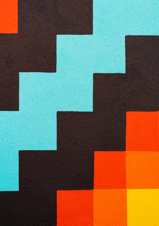 abstract colorful geometric pattern on a concrete wall of a house. Street view, travel photo,...