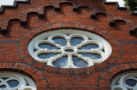 Facade of a historic church with round windows on a brick wall. Victoria BC, Canada. July 23,2021....