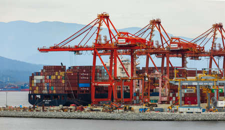 Closeup Industrial port with containers, deepwater port with cranes for container ships in Vancouver, BC, Canada-August 18,2021. Street view, travel photo, selective focus.のeditorial素材
