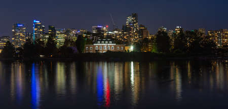 Night photo long exposure of the HMCS Discovery Naval station museum located on Deadmans Island on the nigth lights of Vancouver city in the background. Travel photo, street view.のeditorial素材