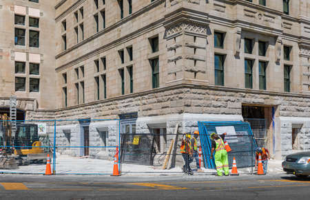 Preparing for road work on the street of a city. Street view of road construction site with bright orange traffic cones. Victoria BC, Canada-July 21,2021. Travel photo, concept photo road worksのeditorial素材