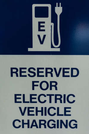 Electric vehicle only, reserved parking sign. Reserved car park slot with paint text word electric vehicle charging. Street view, nobody, selective focusの写真素材
