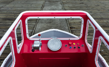 Details of a small ship or boat for children in a playground in a city. Outdoor playground for children with ships. Street view, selective focus, nobody.の写真素材