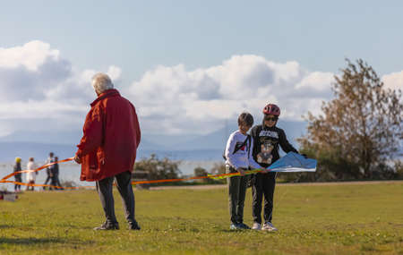 Happy family of three playing in the park Richmond BC, Canada-October 11,2021. Asian family granfather and grandchildren spending time together. Street view, selective focus, concept photo familyのeditorial素材