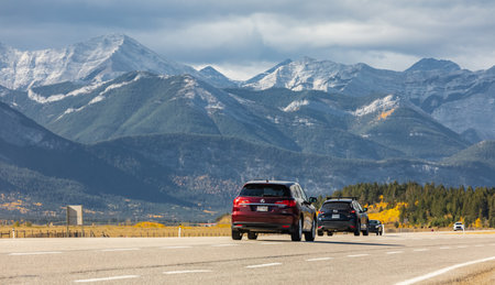 Scenic road in the Canadian Rockies Mountains during a sunny autumn day. Mountain road with Rocky Mountains in a background, Alberta, Canada. Travel photo, selective focus, blurred backgroundのeditorial素材