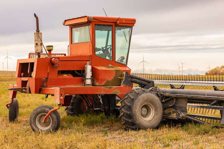 Tractor plowing the fields in spring or autumn season. Street photo, concept photo agriculture, selective focus-September 28,2021-Alberta, Canada.のeditorial素材