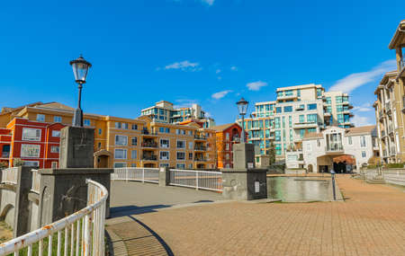 Neighborhood modern houses on sunny day in New Westminster BC, Canada-April 5,2022. Canadian modern residential architecture. Nobody, street photoのeditorial素材