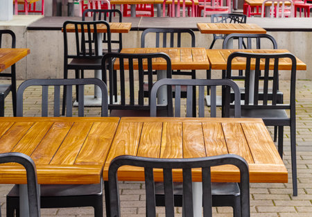 View of empty outdoor cafe in Vancouver BC. Open air cafe with chairs and tables. Street photo,...