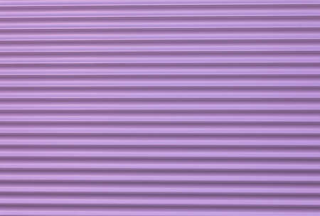 Textured abstract metal fence. Striped purple background. Street photo, nobody, copy space for text.の写真素材