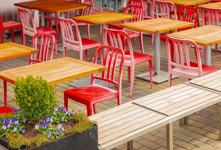 View of empty outdoor cafe in Vancouver BC. Open air cafe with chairs and tables. Street photo,...