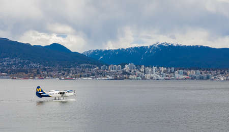 View on The West End of Vancouver across English Bay and seaplane taking off from Harbour. travel...