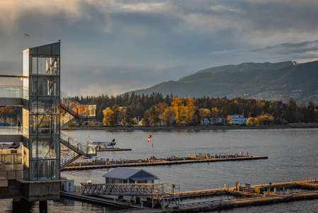 Float planes docked at Vancouver's Harbor Airport during sunset. Air seaplanes at Vancouver Harbor Flight Center Airport-April 11,2022-Vancouver BC, Canada. Travel photography, editorialのeditorial素材