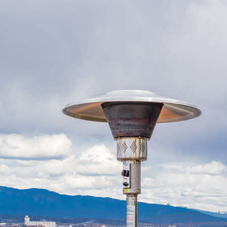Round Mushroom Propane Patio Heater in outdoor restaurant patio. Gas heater for patio-Vancouver BC. Street photo, travel photo, selective focus, nobodyの写真素材
