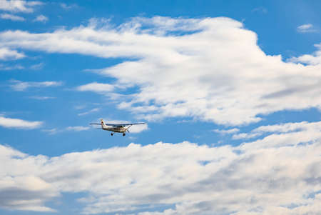 Light plane flying in the cloudy sky. Small airplane in the sky, student is learning how to take off and land on the ground. Travel photo, nobody, copy space for text-May 29,2022-Surrey BC, Canadaのeditorial素材