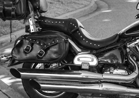 Leather seat of ancient motorcycle outdoor. motorcycle seat. Big bike seat. Close-up seat and wheel of bike. Travel concept, selective focus, street photoの写真素材
