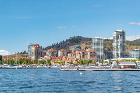 A view of the Kelowna Skyline and Okanagan Lake British Columbia Canada in the summer. Cityscape on sunny summer day. Kelowna Boardwalk. Travel photo, copyspace for text-June 7,2022のeditorial素材
