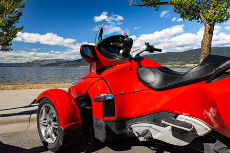 Roadster BRP Can-Am Spyder F3 on a background of the blue sky and mountains on a sunny summer day in...