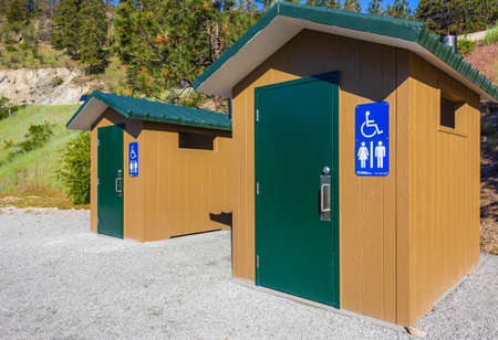 Modern public toilet outdoor. Modern toilet building, outdoor, summer time in a park. Front view of...