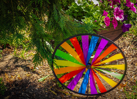 Colorwindmill. Multicolor Pinwheel in garden. Rainbow garden pinwheel on a sunny day. Nobody, selective focus, street photoの写真素材