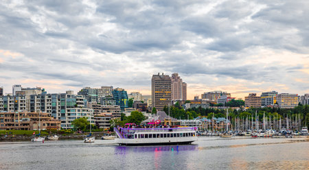 False Creek, Marina and ship or boat. Beautiful view of Vancouver skyline with harbor at sunset BC Canada. harborfont sunset. Travel photo, street view, copy space for text, editorial-July 7,2022のeditorial素材