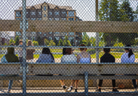 Summer activities for students. Children playing football, soccer on outdoor stadium. Group of...