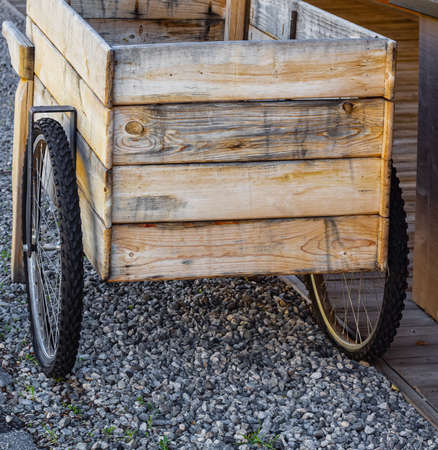 One vintage wooden cart on a street. A wooden box street vending bicycle. Nobody, street photo.の写真素材