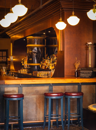 Bar table with alchol night amasument center. Restaurant interior. Empty pub with barstools and bottles. Restaurant lobby, modern but vintage look-July 10,2022-Vancouver Canada. travel photo, blurredのeditorial素材