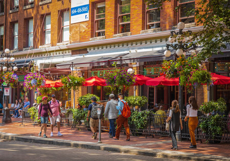 People walking on the street of Vancouver. Gastown area is a must-stroll for most visitors to Vancouver.One of the oldest commercial streets best-known shopping-July 10,2022-Canada, travel photoのeditorial素材