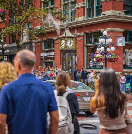 Tourists gather around Steam Clock in historic Gastown, Vancouver's first downtown core is named after Gassy Jack Deighton, who in 1867 opened the area's first saloon. Travel photo-July 10,2022-Canadaのeditorial素材