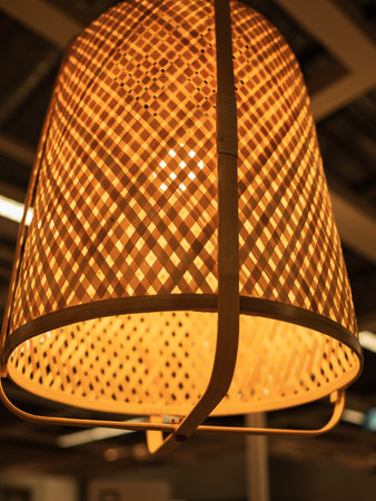 Bamboo pendant light. Wicker handmade chandelier lamp on the wooden ceiling. Eco natural style,...
