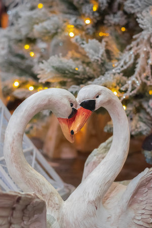 Two wooden white swans. Couple of swans in love. home decor concept. Nobody, selective focus.の写真素材
